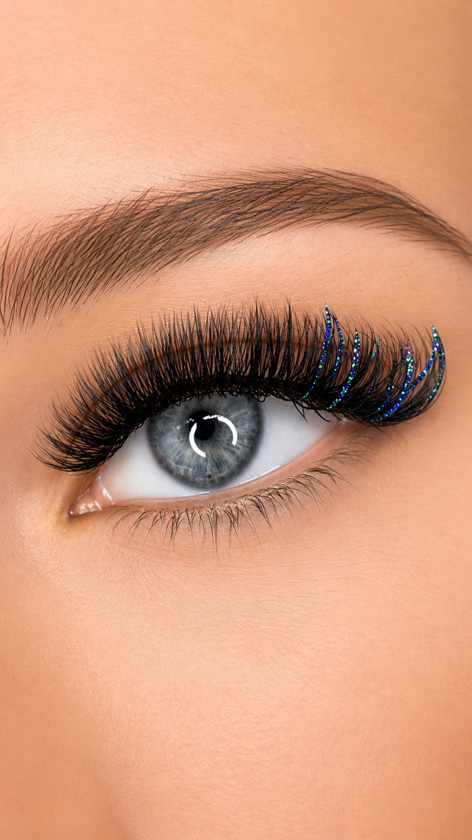 Custom colored lash extensions with emerald and sapphire glitter accents